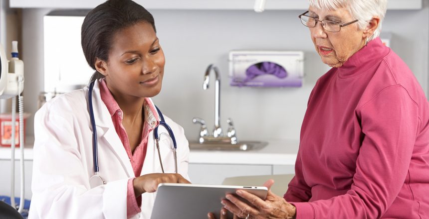 Doctor Discussing Records With Senior Female Patient